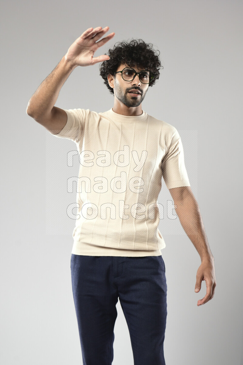 A man wearing casual standing and making a hand gesture on white background
