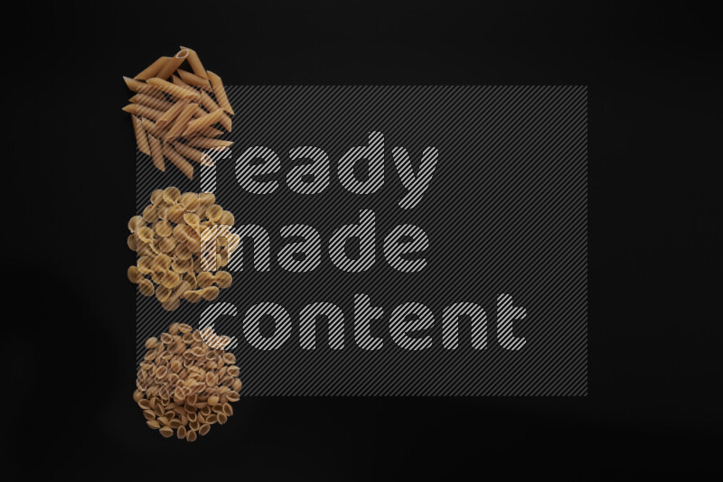Different pasta types in 3 bunches on black background