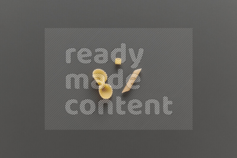 Different pasta types on grey background