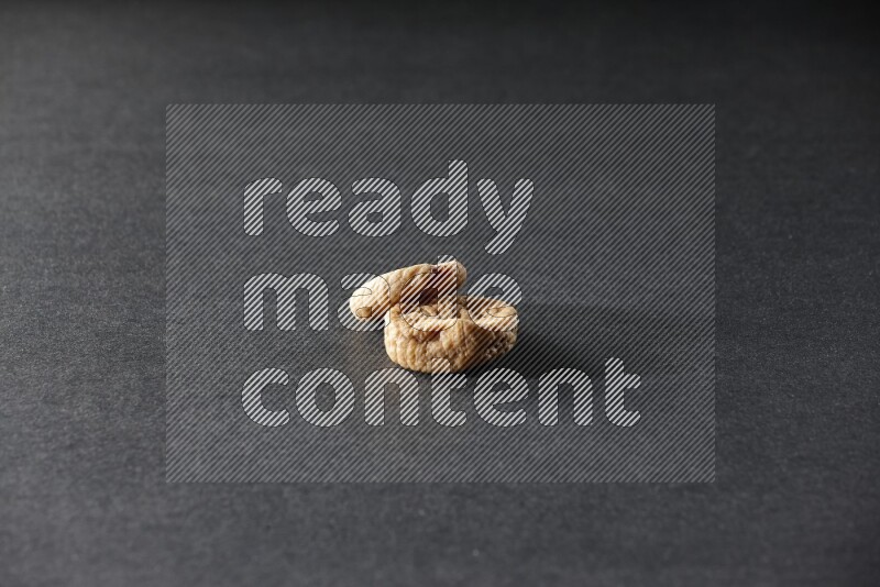 Two dried figs on a black background in different angles