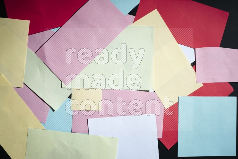 Multicolored paper sheet on black background