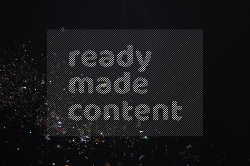 Falling multicolored confetti on black background