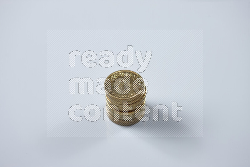 Stack Egyptian 50 piasters coins on grey background