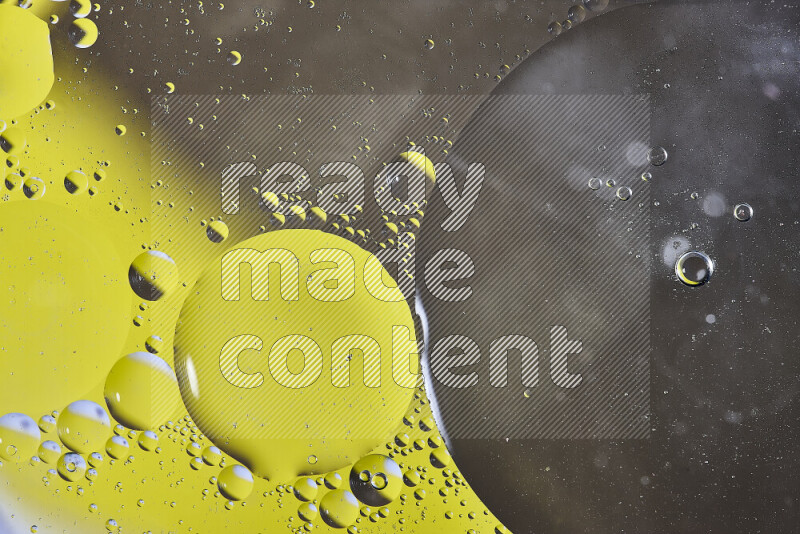 Close-ups of abstract oil bubbles on water surface in shades of yellow and brown