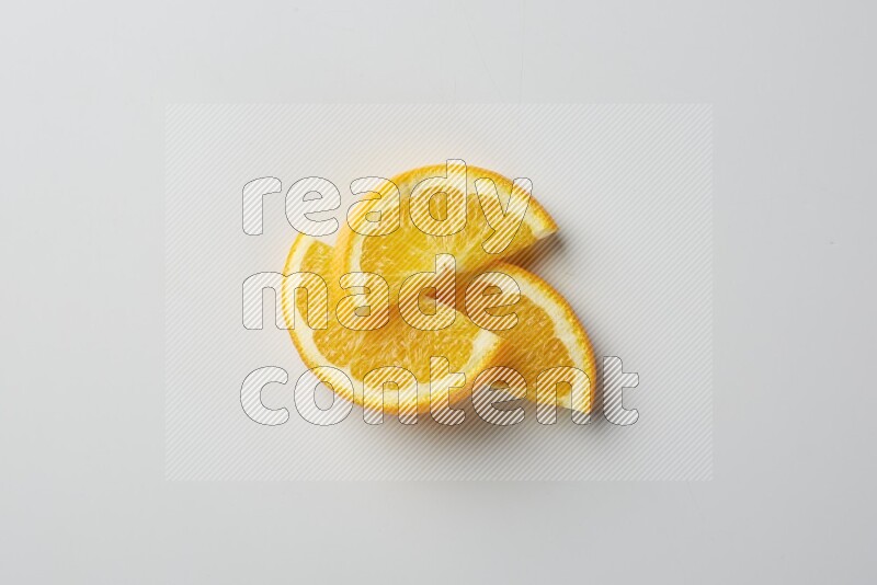 Three halves of an orange slices on white background