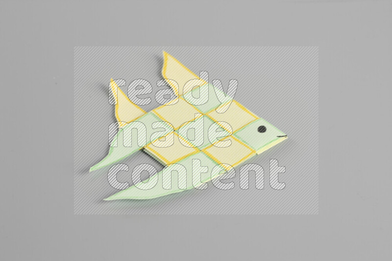 Origami fish on grey background