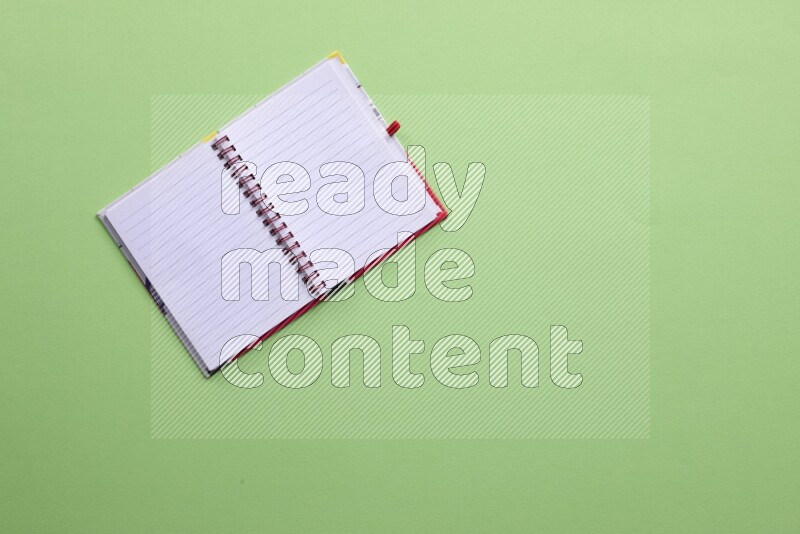 A blank open notebook on green background