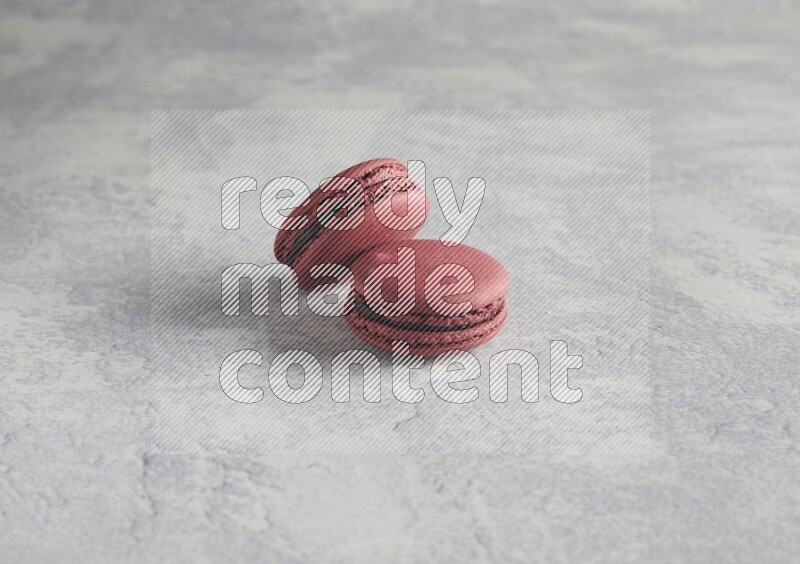 45º Shot of two Red Cherry macarons  on white  marble background