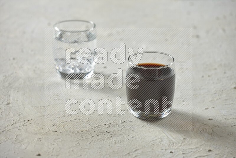 Cold drinks in a glass cup such as water, tamarind, qamar eldin, sobia, milk and hibiscus on textured white background