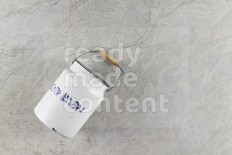 A vintage milk can on grey marble background