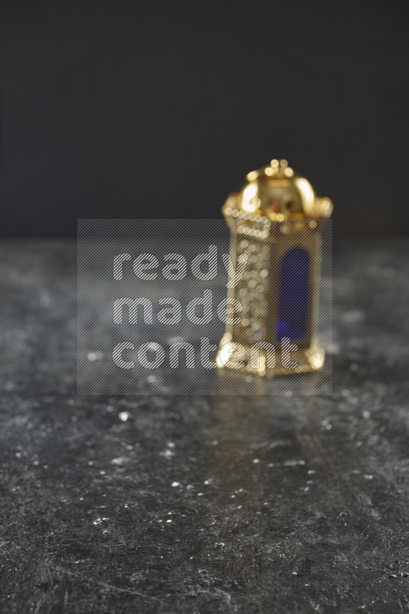 An out of focus lantern on textured black background