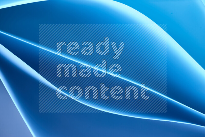 This image showcases an abstract paper art composition with paper curves in blue gradients created by colored light