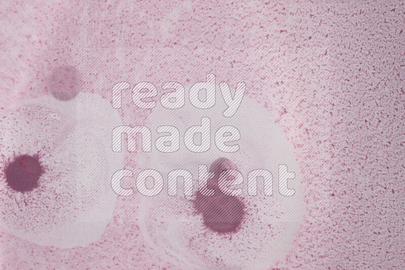 The image captures a dramatic splatter of purple paint over a white backdrop