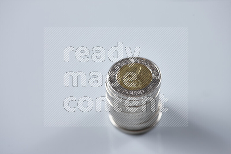 Stack Egyptian one pound coins on grey background