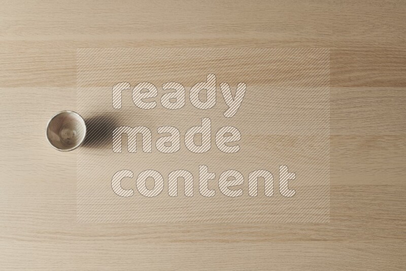 كأس فخاري على خلفية خشبية فاتحة