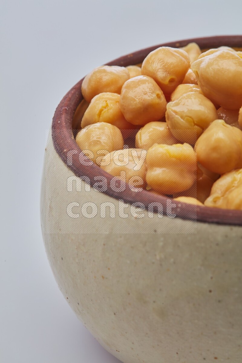 Close up of a boiled chickpeas in a container on white background