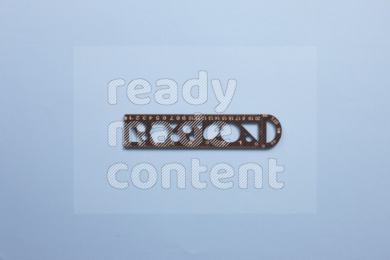 A wooden ruler on blue background