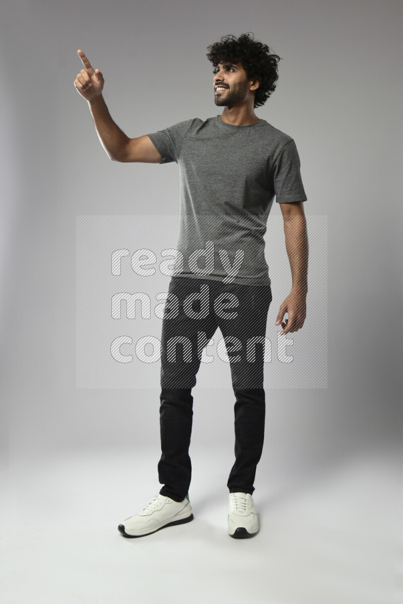 A man wearing casual standing and making a hand gesture on white background
