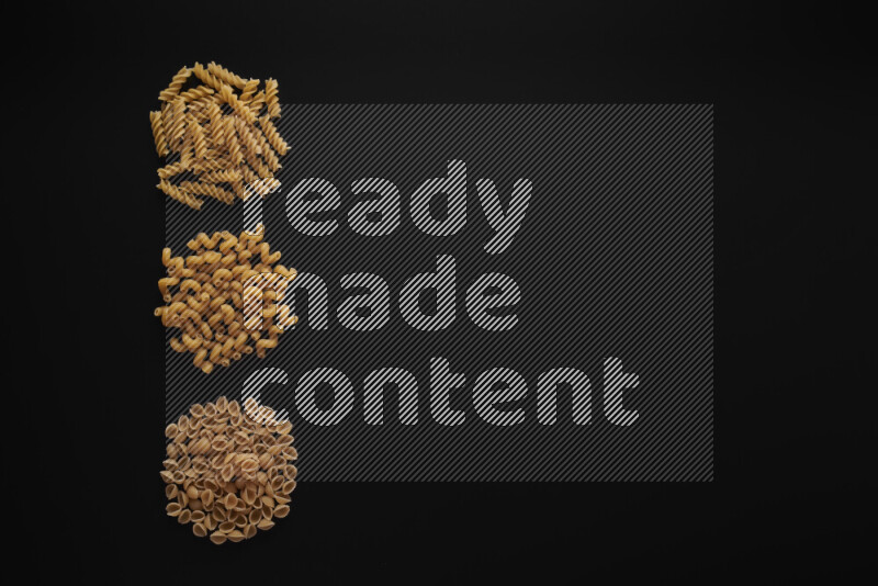 Different pasta types in 3 bunches on black background