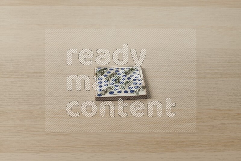 A decorative coaster on light wooden background