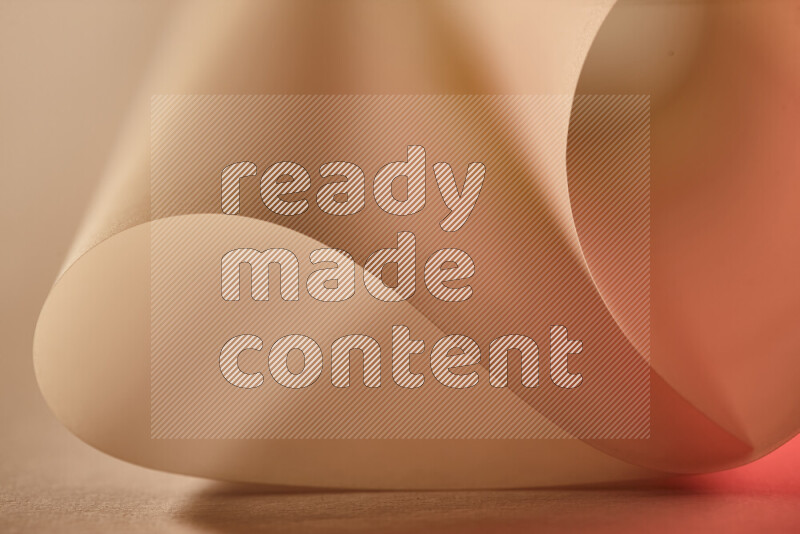 An abstract art piece displaying smooth curves in gold and red gradients created by colored light