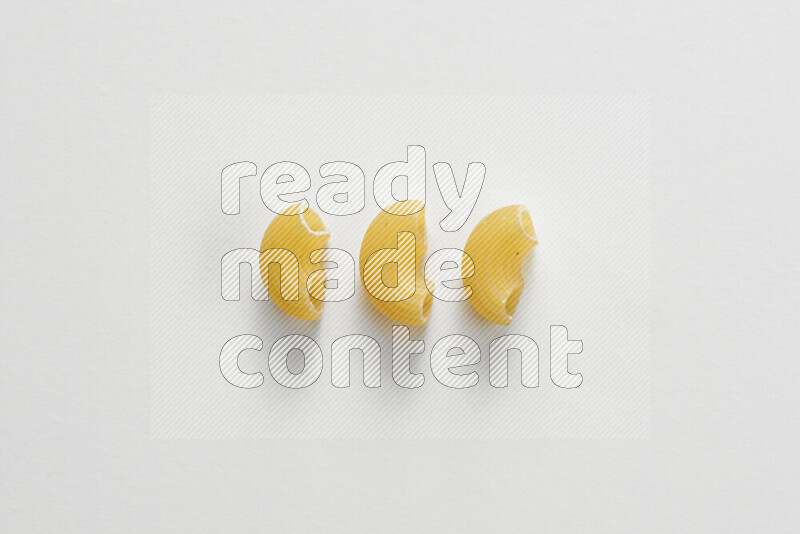 Elbow pasta on white background