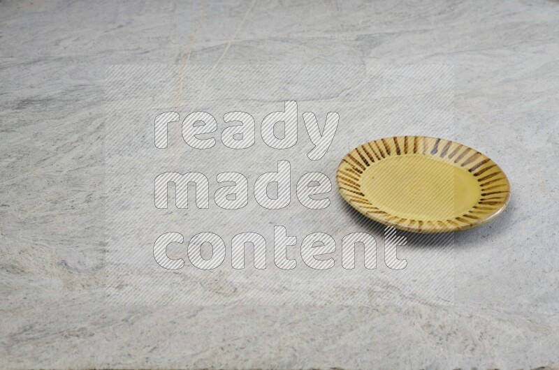Multicolored Pottery Plate On Grey Marble Flooring