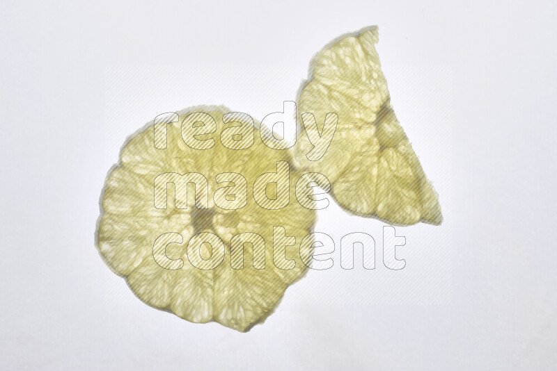 Orange slices on illuminated white background