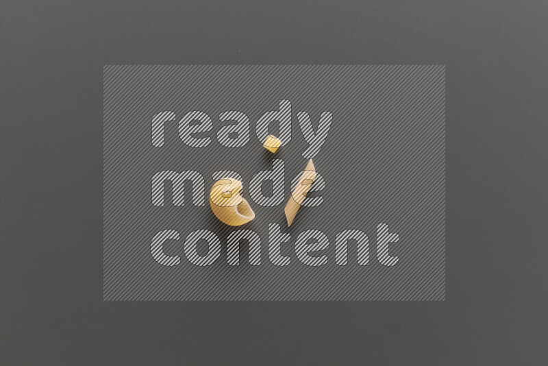 Different pasta types on grey background