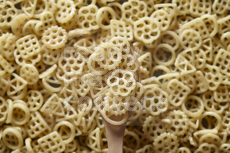 A wooden spoon full of snacks on snacks background