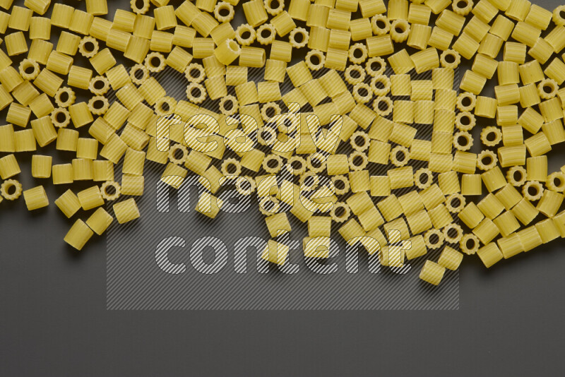 Small rings pasta on grey background