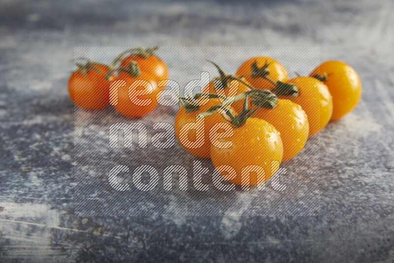 Mixed cherry tomato veins on a textured rustic blue background 45 degree