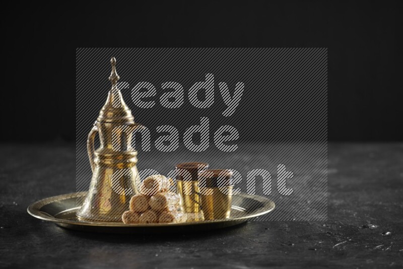 Golash with a drink on a metal tray in a dark setup