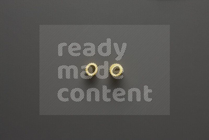 Big rings pasta on grey background