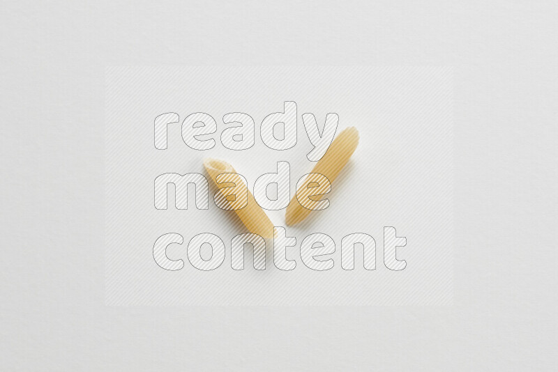 Mini penne pasta on white background