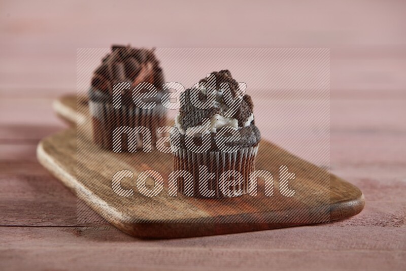 Chocolate mini cupcake topped with oreo on a wooden board