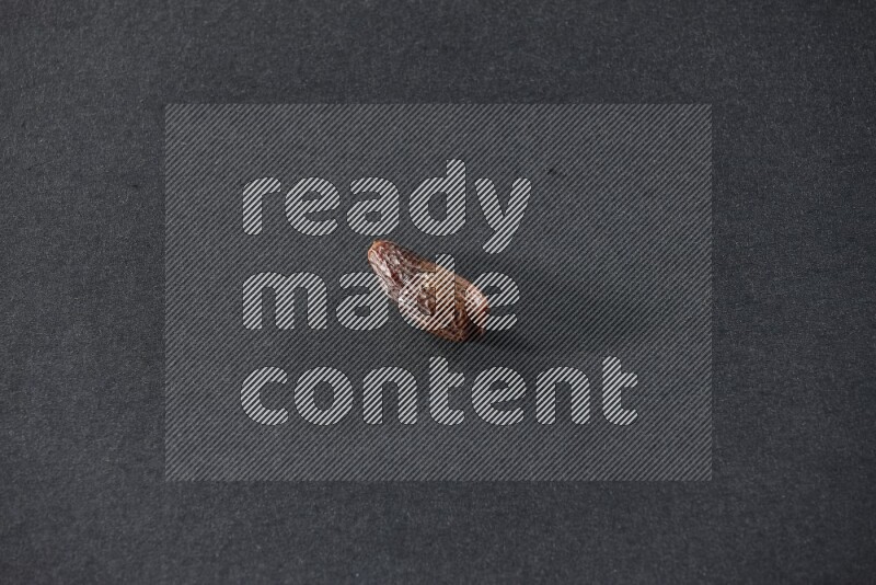 Dried dates on a black background in different angles