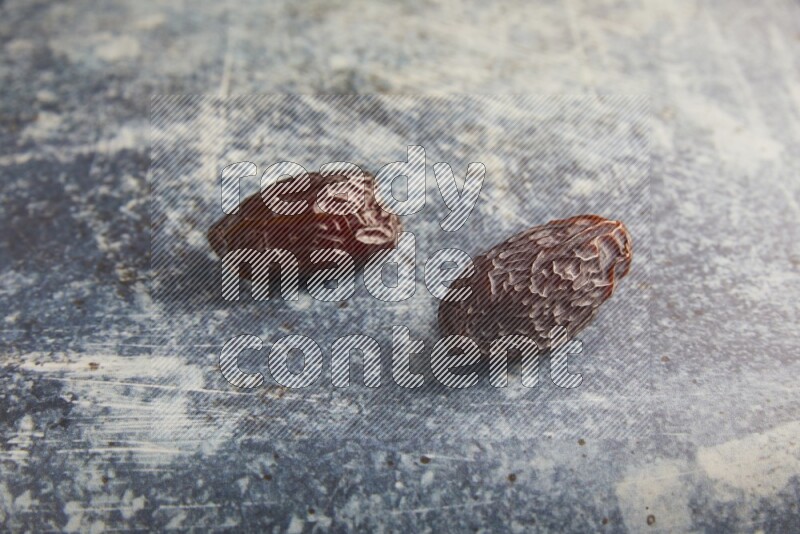 two madjoul dates on a rustic blue backround