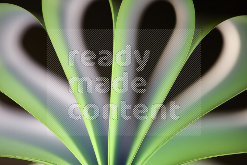 An abstract art piece displaying smooth curves in white and green gradients created by colored light