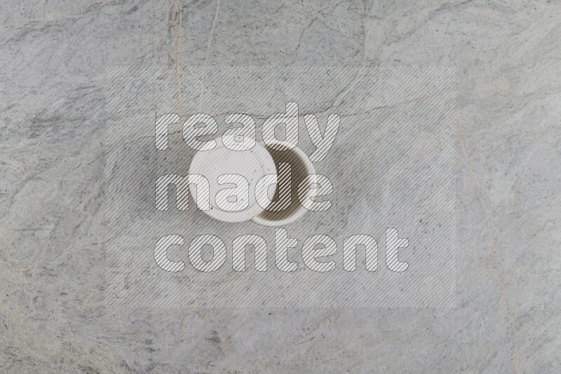 A multicolored pottery Cup on grey marble background