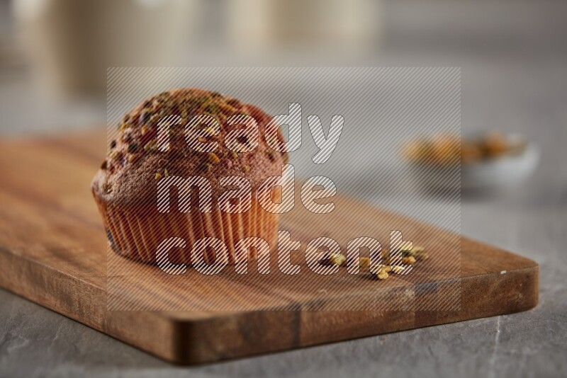 Pistachio cupcake on a wooden board