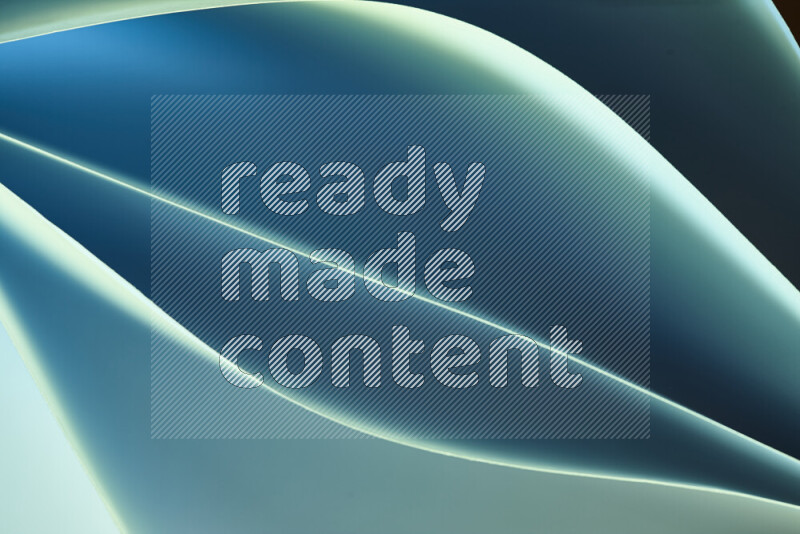 This image showcases an abstract paper art composition with paper curves in green and blue gradients created by colored light