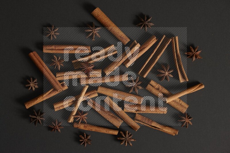 Cinnamon sticks and star anise on black background