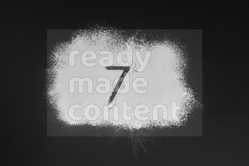 Numbers written with powder on black background