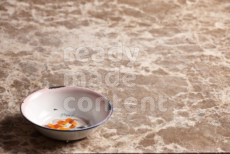A vintage metal plate on beige marble background