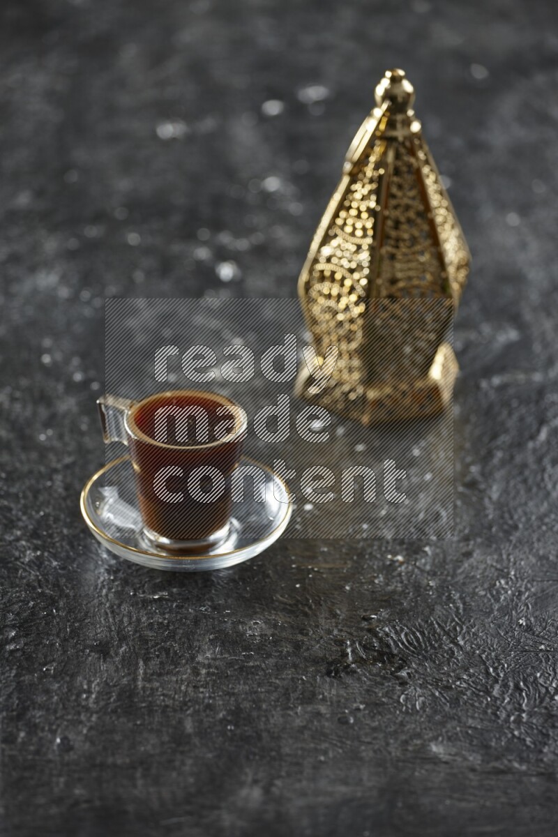A golden lantern with different drinks, dates, nuts, prayer beads and quran on textured black background