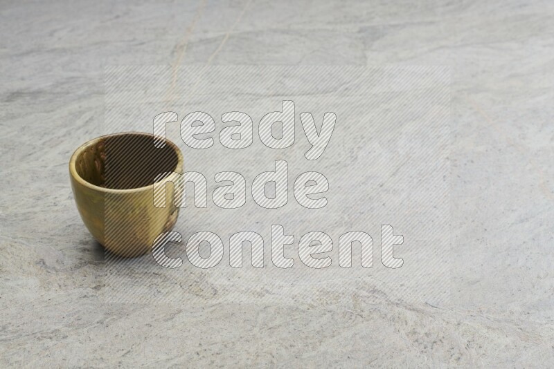 A multicolored pottery bowl on grey marble background