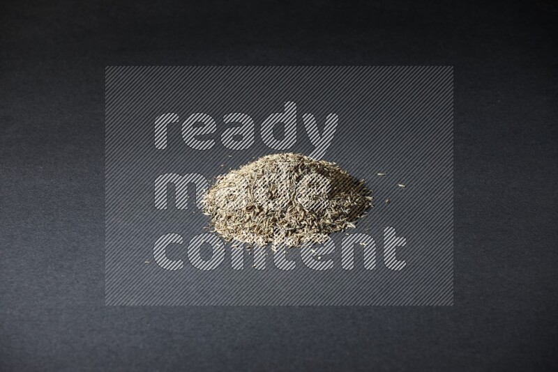 Cumin seeds on black flooring