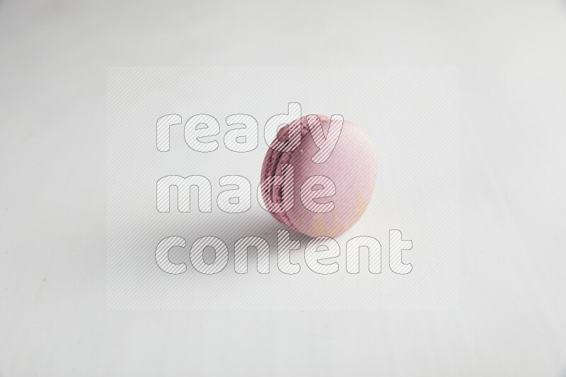 45º Shot of Purple Strawberry macaron on white background