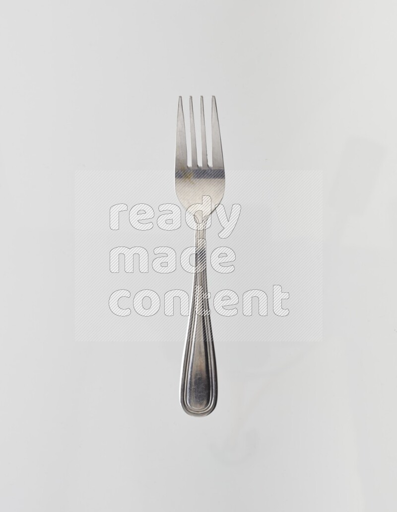 Silver stainless steel fork on white background